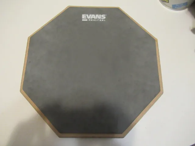 Gray EVANS RealFeel octagonal practice pad with a wooden edge, photographed on a table